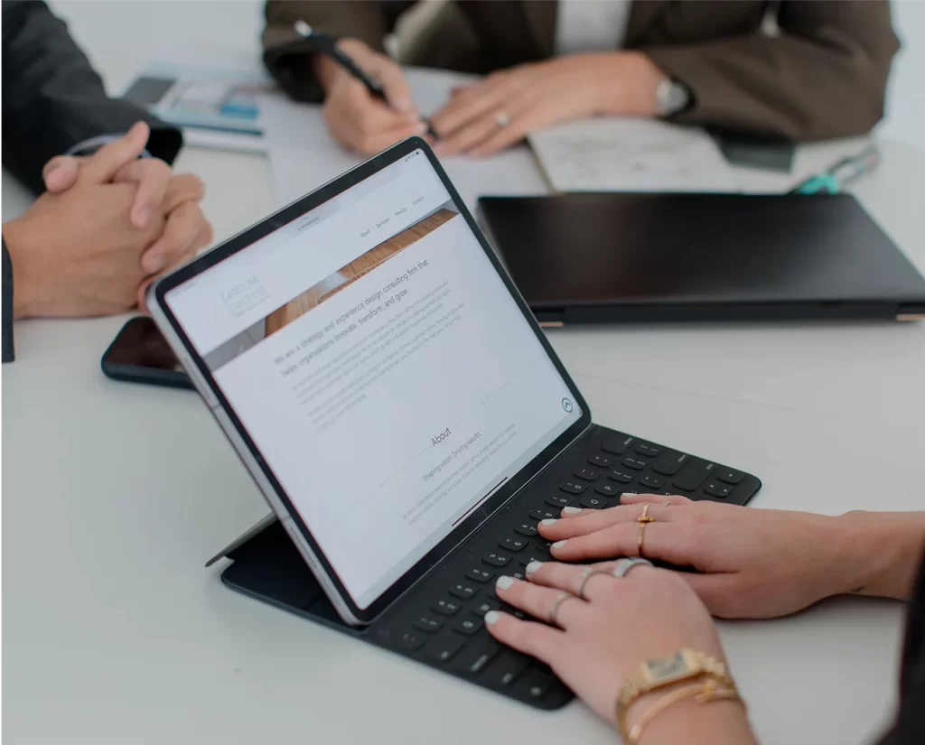 Hands typing on a laptop, strategizing business transformation and digital innovation at Caroline Stacey & Co.